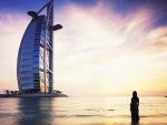 girl walking towards nurj al arab hotel in dubai