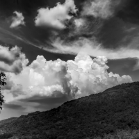 clouds over a mountain in black and white