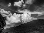 clouds over a mountain in black and white