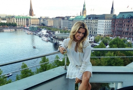 Sylvie in Hamburg - white dress, balcony, blonde, city in background