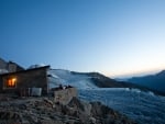 stone alpine cabin at dusk