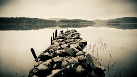 rocky wharf in a lake in monochrome - lake, wharf, monochrome, rocks