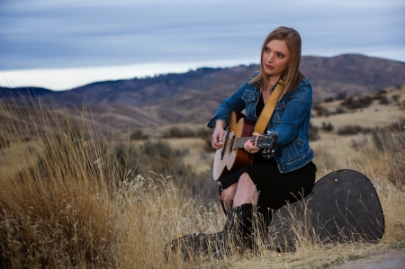 Cowgirl Eilen Jewell - mountains, guitar, eilen jewell, hills, songwriter, weeds, cowgirl, case, field, singer, trees, guitarist, boots