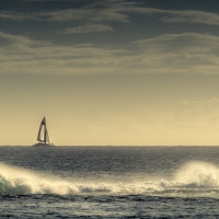 sailboat beyond the waves