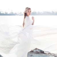 Beautiful blonde girl in a white dress