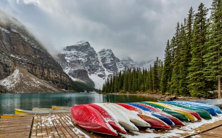 First Snowfall at Moraine Lake - canoes, lake, forest, snow, canada, mountains