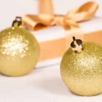 Golden Baubles By The Christmas Present