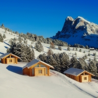 Cabins on snowy mountain slope