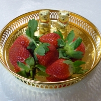 Strawberry on a golden plate