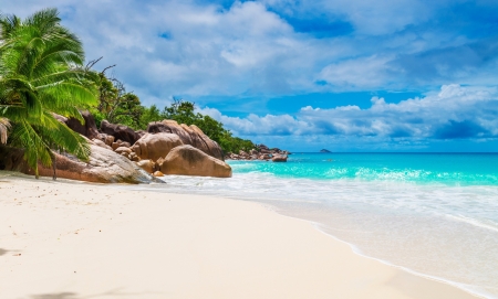 Tropical Beach - sky, sunshine, beach, trees, paradise, water, coast, rocks, vacation, clouds, tropic, skyphoenixx1, ocean, tropical, shore, summer, isle, waves, nature, holidays, island, sea