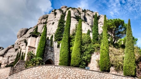 abbey of montserrat in catalonia spain - hill, trees, abbey, rocks, sky