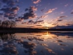 clouds reflected in a lake at sunrise