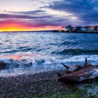 gravel beach by a ferry pier at sunset