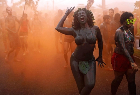 Carnival parade Paraty Brazil 2011 - mud block carnival group parade, orange smoke, bloco da lama, brazil 2011, dancing