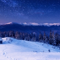 wintry mountain cabin under starry sky