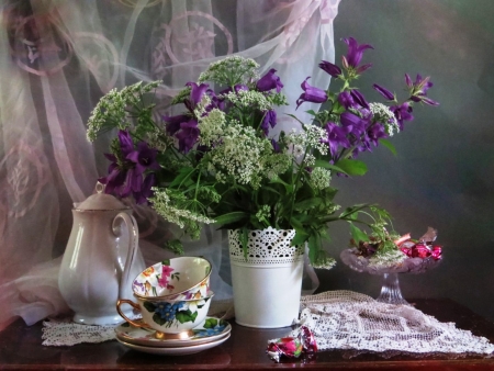 Still life - cups, different, flowers, purple, table, beauty, kettle, colors, tea, freshness, still life, drink, white, nature, green, arrangement, soft