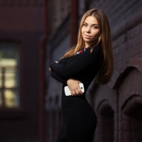 Woman in black dress with smart phone