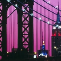 Manhattan Bridge and the Empire State Building illuminated with red white and blue lights in New York City New York