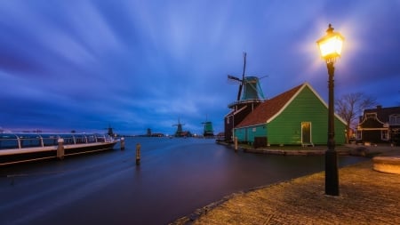 windmills in a holland town at twilight - windmills, town, lamp, river, boat, twilight