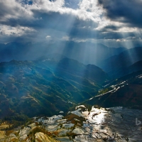 Sunlight reflecting on rice paddy terraces Yuanyang County China