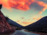 colorful clouds over valley road