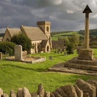 church and cemetery under dark clouds