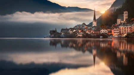 sunrise on the gorgeous town of hallstatt austria - lake, mountains, town, fog, church, sunrise