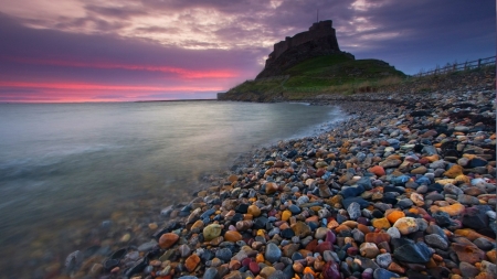 castle ruins on colored stones beach