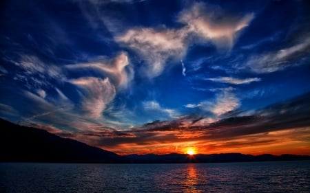 Lakeside Sunset - sky, reflection, hills, sun, clouds, water