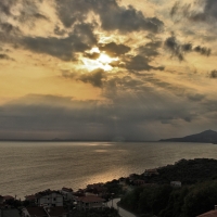 sunset rays over seaside town