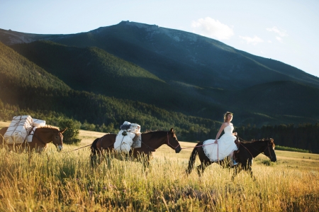 Cowgirl Bride - bride, hills, boots, packages, cowgirl, Montana, horses, mountains, grassland