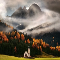 beautiful little church infront of italian mountains in fall