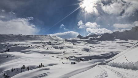 looking up at a snow covered mountain - winter, cabins, snow, sunshine, mountain, sky