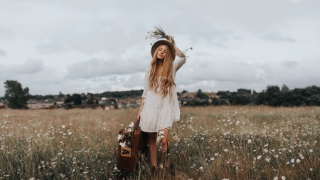 Traveling Cowgirl - houses, hat, trees, cowgirl, field, luggage, suitcase, clouds, homes, brunette, flowers, daisies, dress