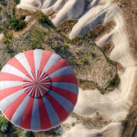 above a hot air balloon over sand dunes