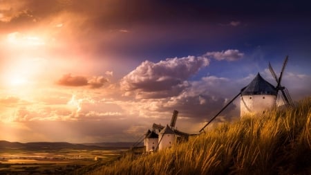 windmills on a hill overlooking a valley - clouds, wheat, hills, windmills, valley, sky