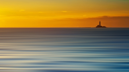 lighthouse on a blue carpet sea at sunset - horizon, sunset, lighthouse, blue, sea