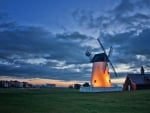 windmill near a town at sunset