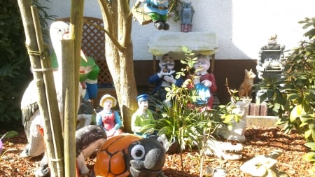 The garden idyl family - snapshot, figurine, summertime, pig, sun, frog, gandpa, swing, painted, sunny, owl, smoking, tree, photograph, garden, scene, figurines, pipe, summer, bird, fox, fairytale, turtle, animal, painted figurines, photo, grandma, grandparents