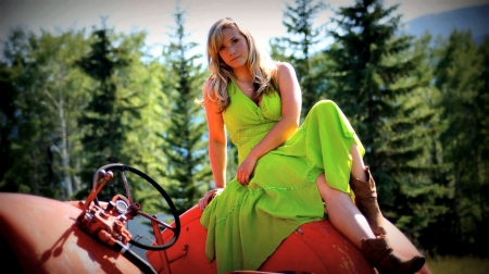 Sitting On Her Tractor.. - girls, women, style, fun, models, tractors, trees, female, cowgirl, fashion, boots, outdoors, western, blondes, ranch