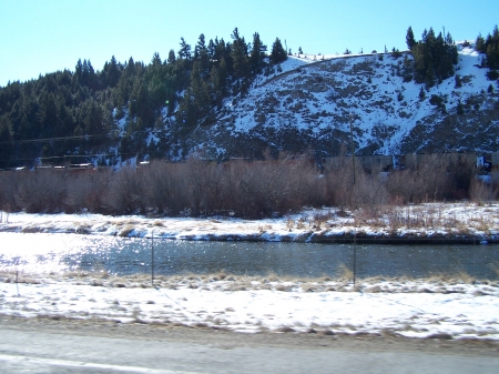 Coal cars along Montana riverbanks - mountains, rivers, trains, scenic