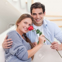 Young man gives flower