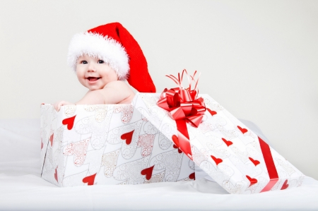 A Christmas surprise - craciun, gift, hat, copil, child, surprise, christmas, white, santa, baby, box, red, cute