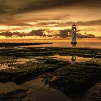 Lighthouse in Golden Horizon