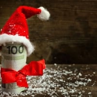 Gift money with red ribbon and Santa cap