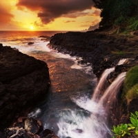 Waterfall on the coast at sunset