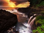 Waterfall on the coast at sunset