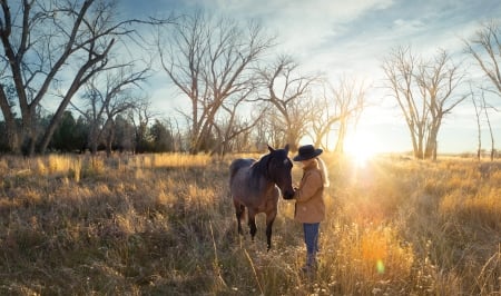 Morning Greetings - rays, hat, trees, sun, cowgirl, jeans, field, bloned, horse, coat, sunrays