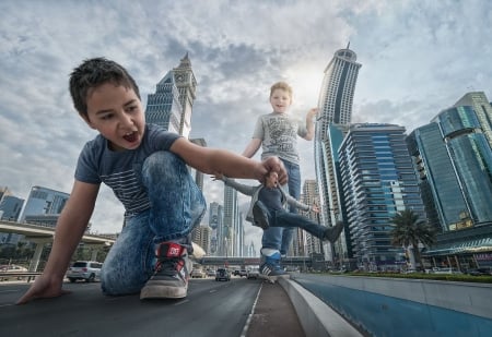 Giants in Dubai - street, copil, fantasy, creative, buildings, giant, children, situation, adrian sommeling, boy, city