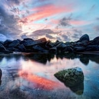 Pink Sunset Above the Rocky Lake